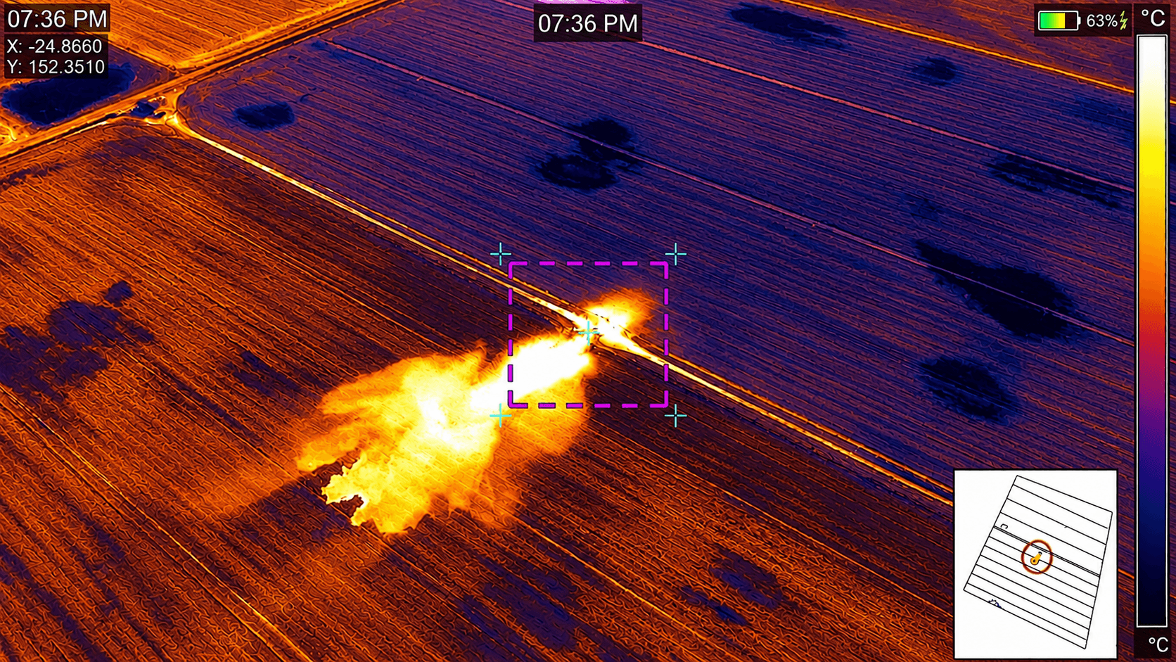 Aerial thermal view of a bright yellow fire spreading across dark purple field rows.